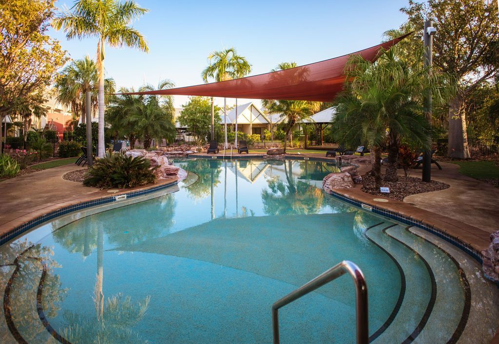 A large swimming pool with stairs leading to it