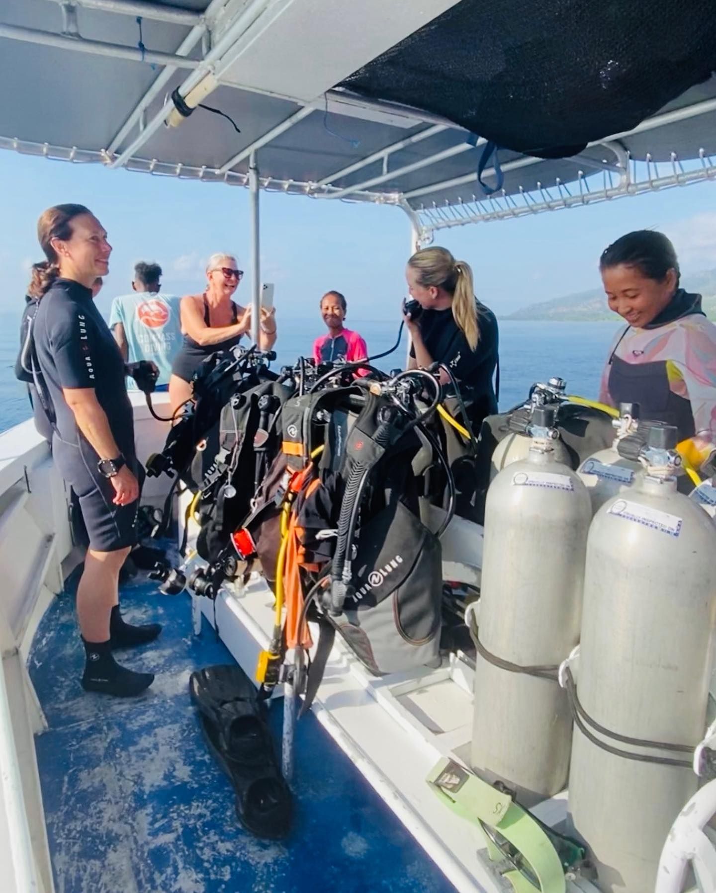 A group of people on a boat with scuba gear