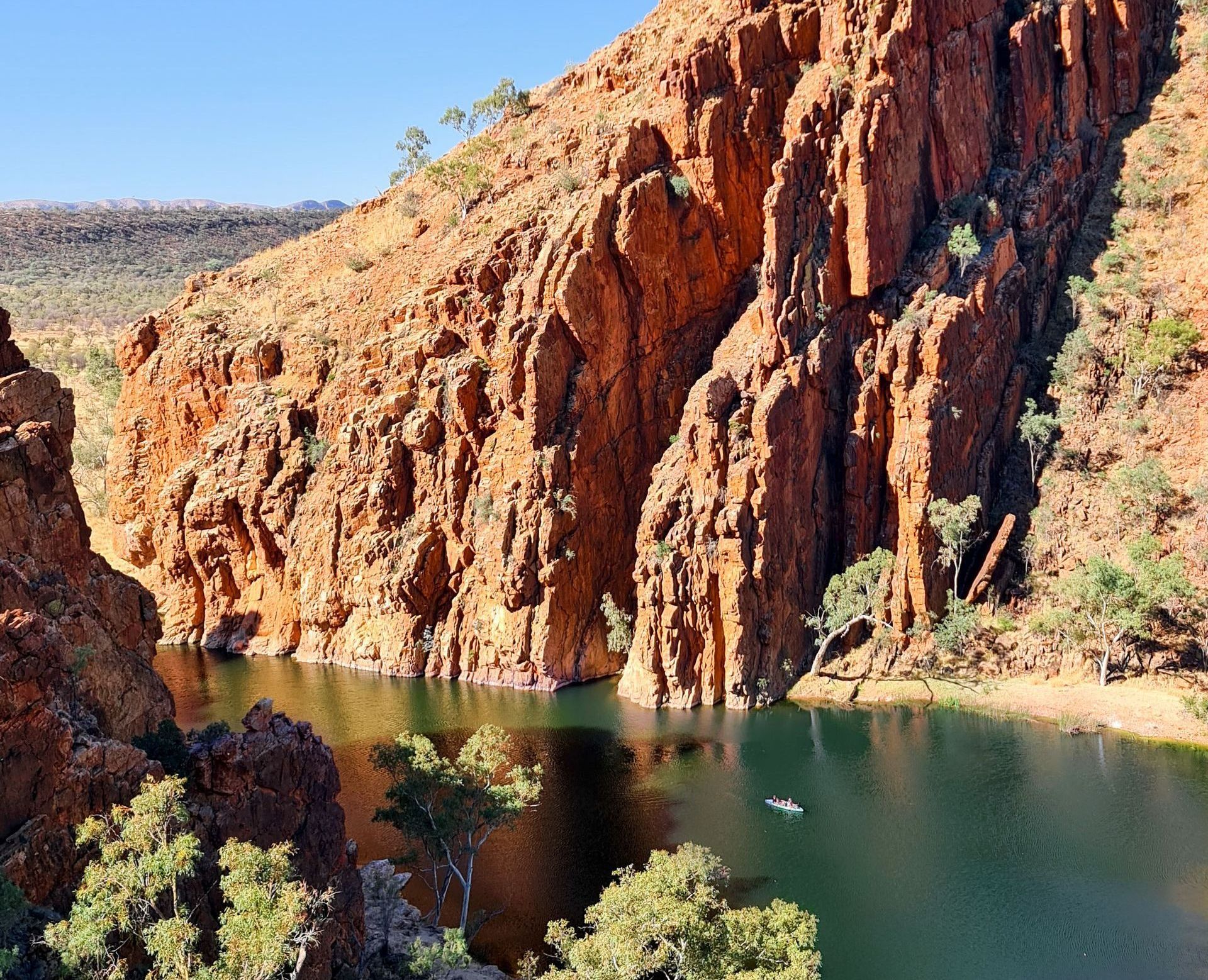 A large body of water surrounded by rocks and trees