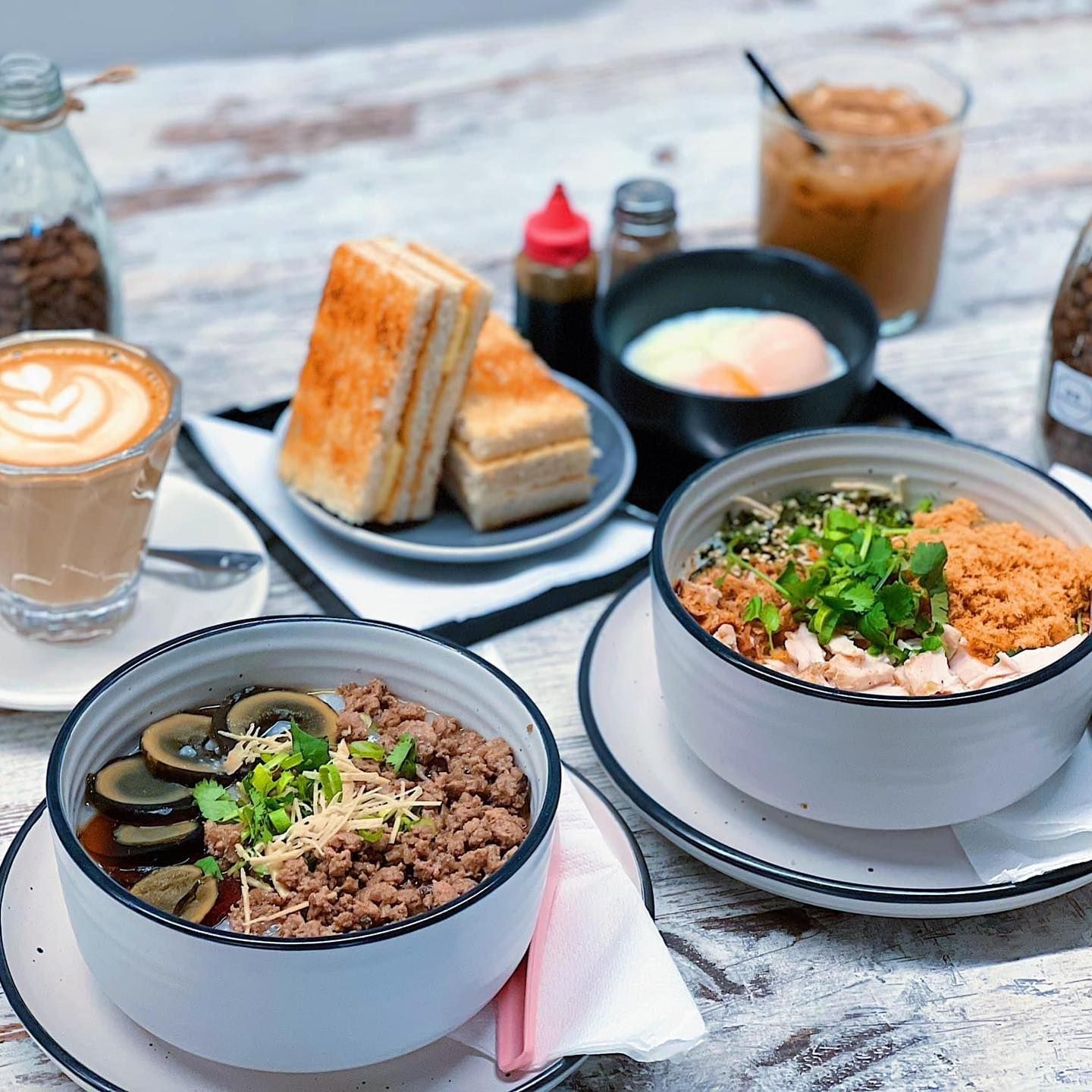 A table topped with bowls of food and drinks