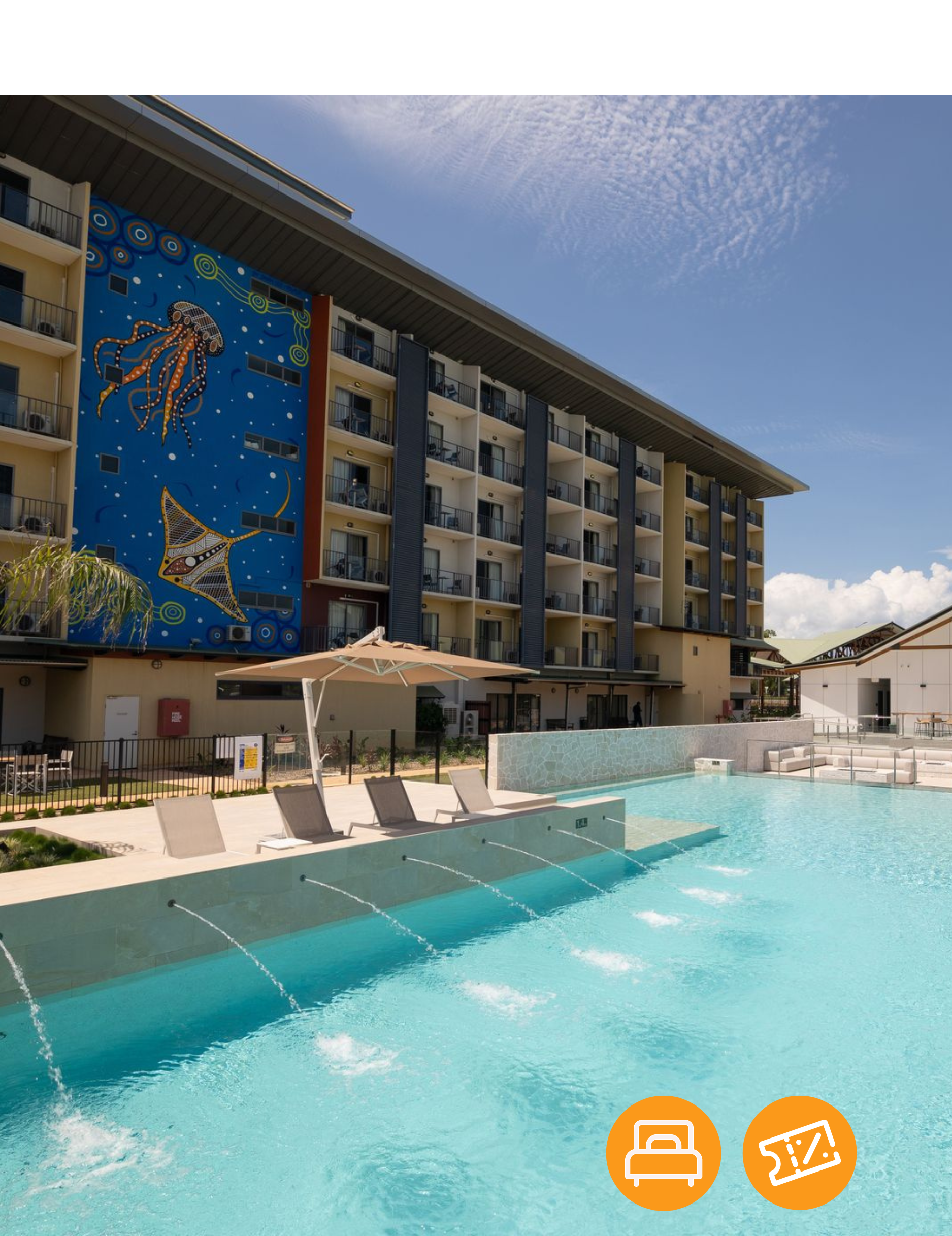 A large building with a swimming pool in front of it