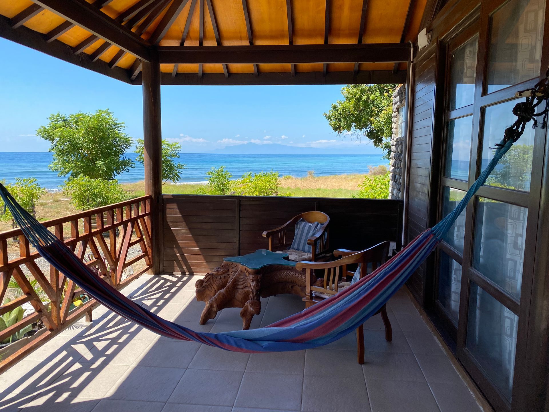 A hammock on a balcony overlooking the ocean