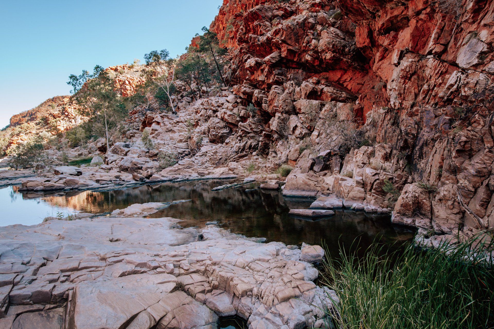 A river runs through a rocky landscape with mountains in the background.