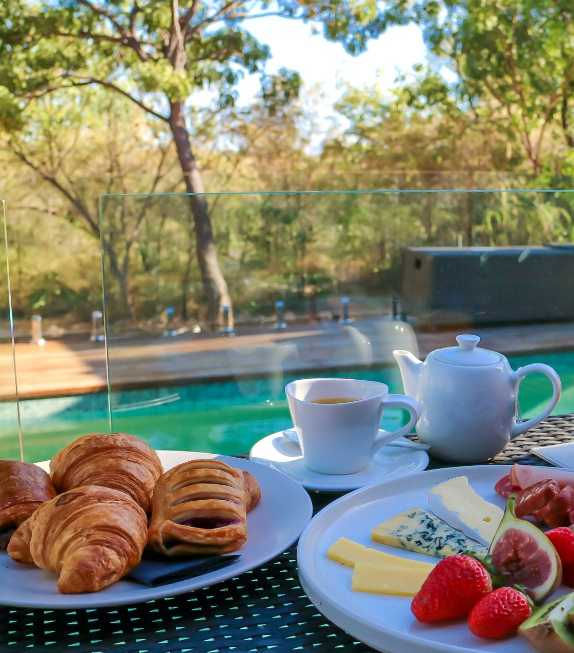 A table with plates of food and a cup of tea