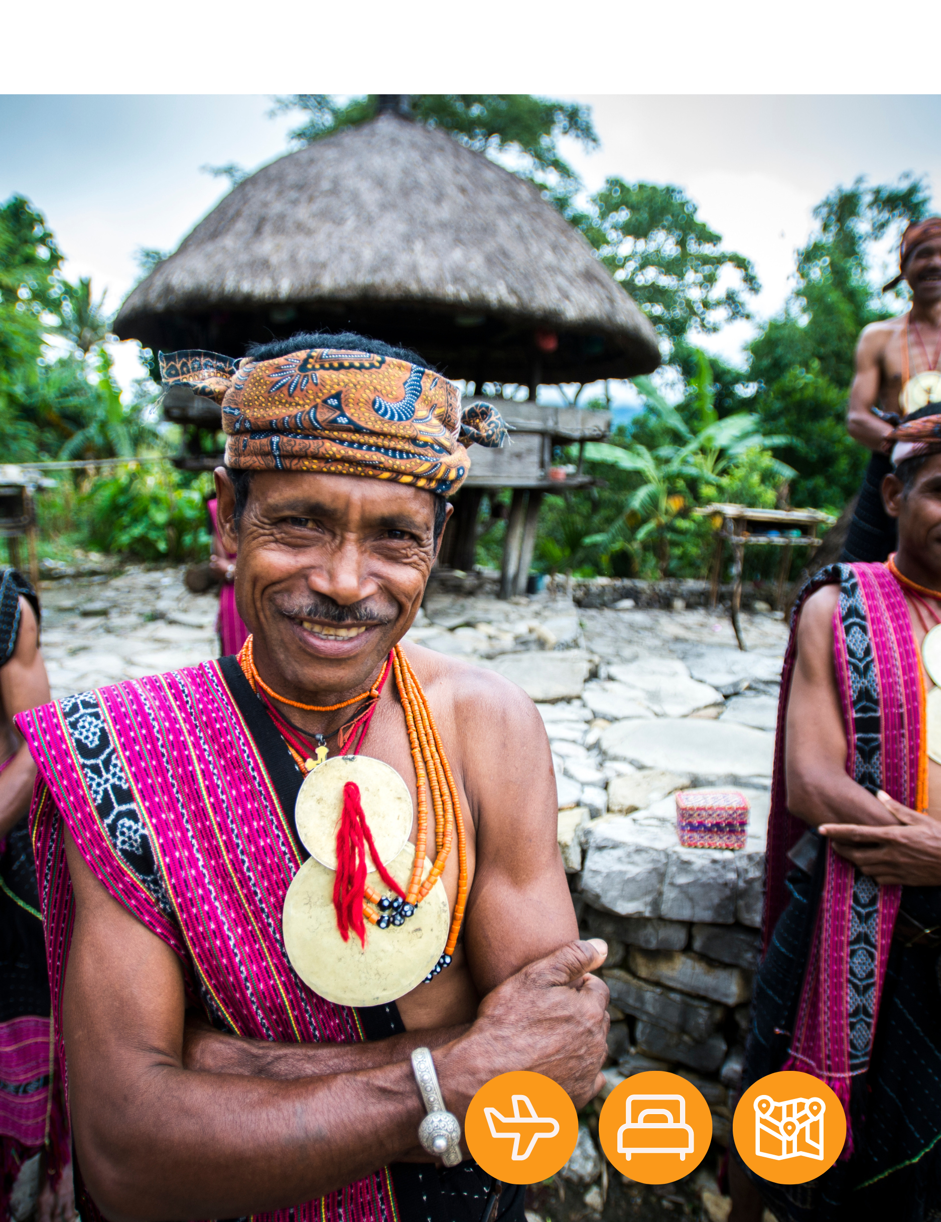 A group of men are standing next to each other in front of a thatched hut.