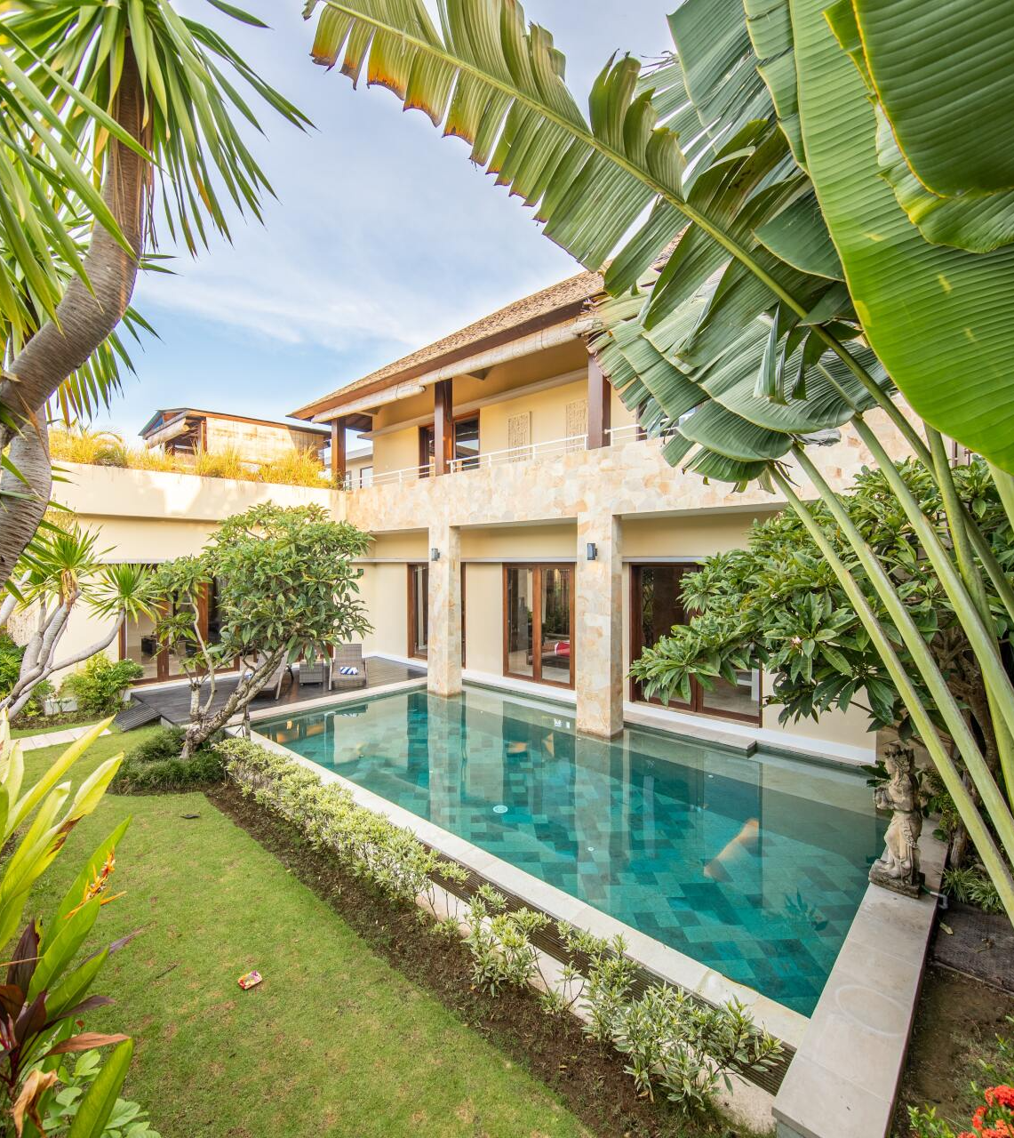 A large house with a large swimming pool in front of it