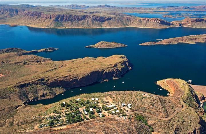 An aerial view of a large body of water surrounded by mountains.