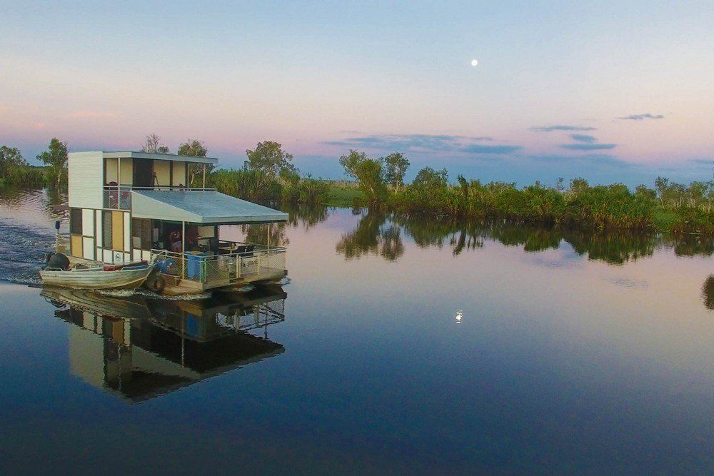 A houseboat is floating on top of a body of water.