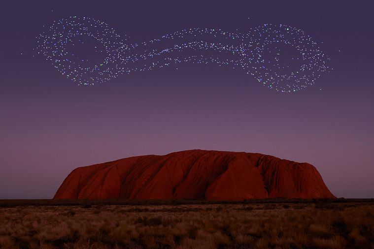 A mountain with a lot of stars in the sky above it.