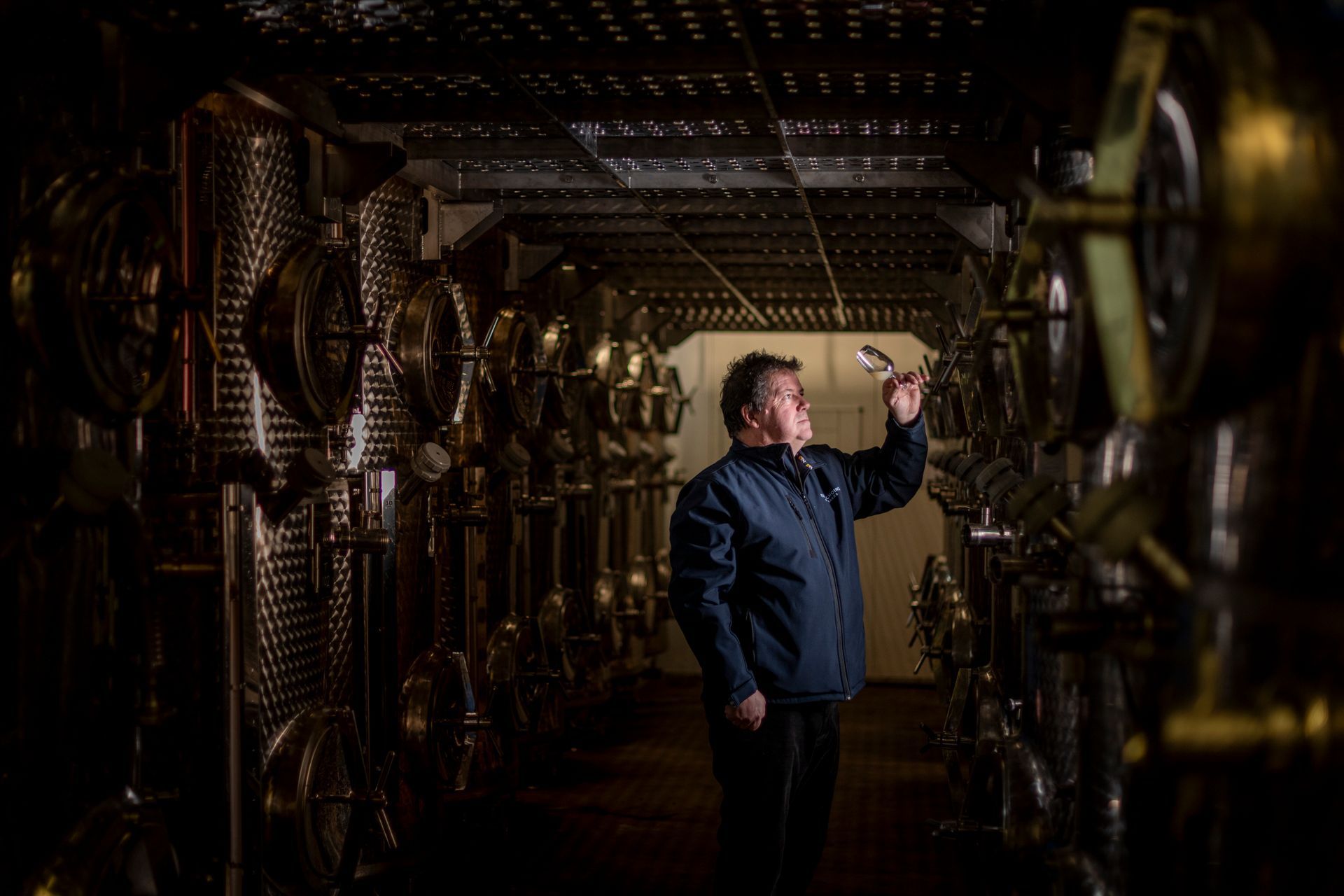 Martin, the winemaker, stood in the winery at Three Choirs inspecting a glass of wine