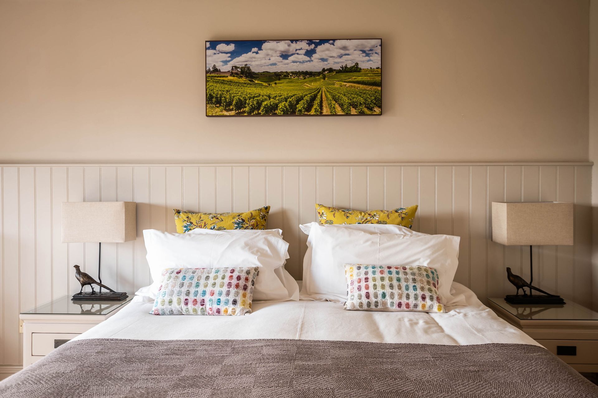 A double bed in one of the deluxe rooms