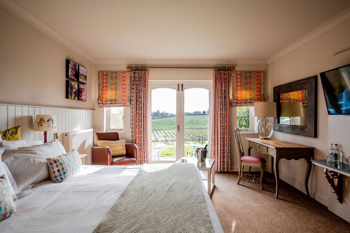 a bedroom with a bed a chair and a table