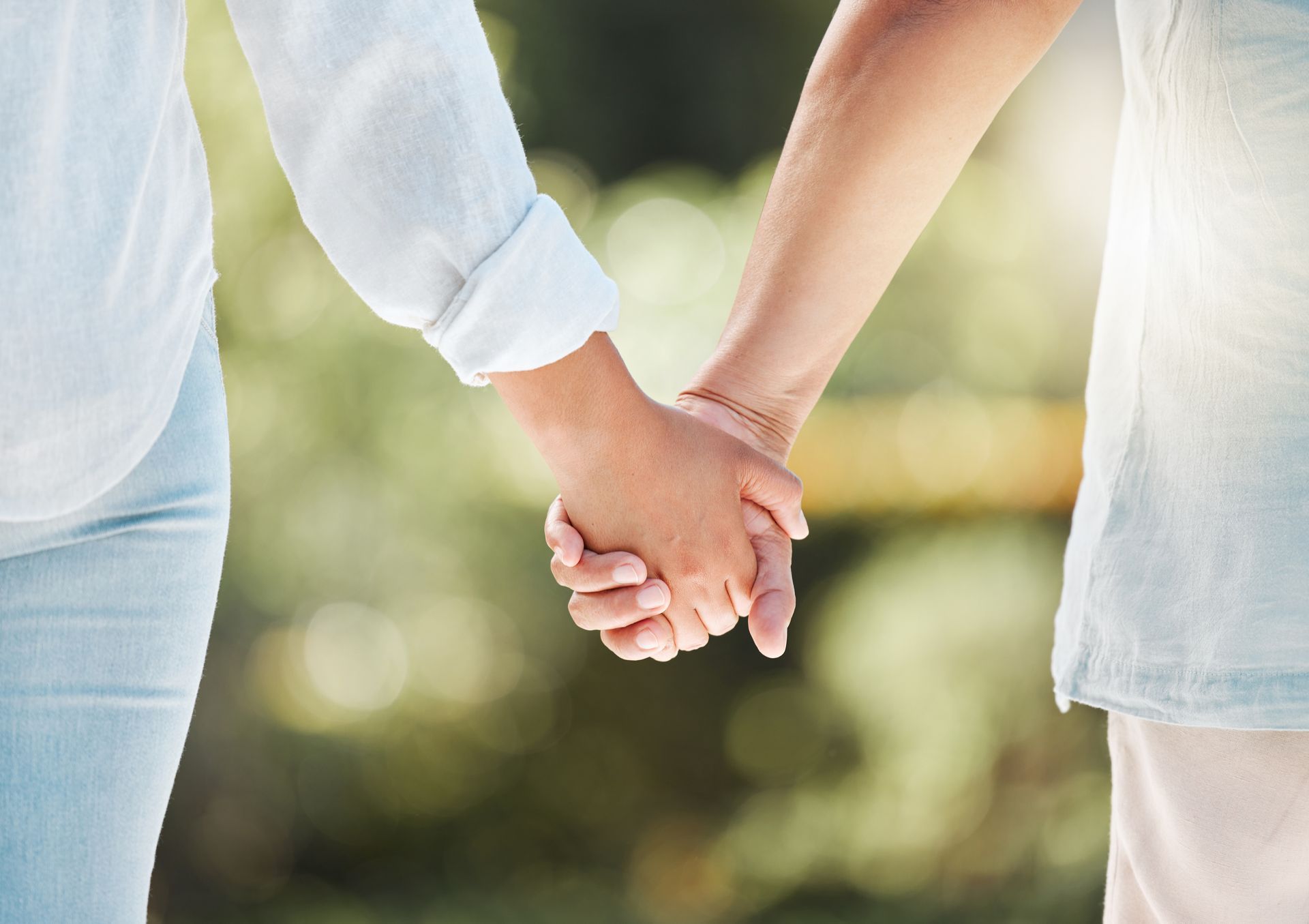 Newlyweds enjoying a romantic getaway, holding hands, walking through the peaceful vineyard landscape
