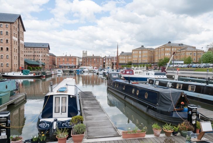 several boats are docked in a harbor including one that says aqua