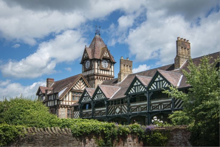 a large house with a clock tower on top of it .