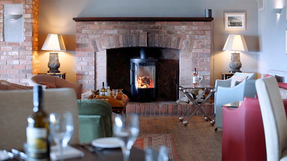 a man and a woman are standing in a vineyard talking to each other .