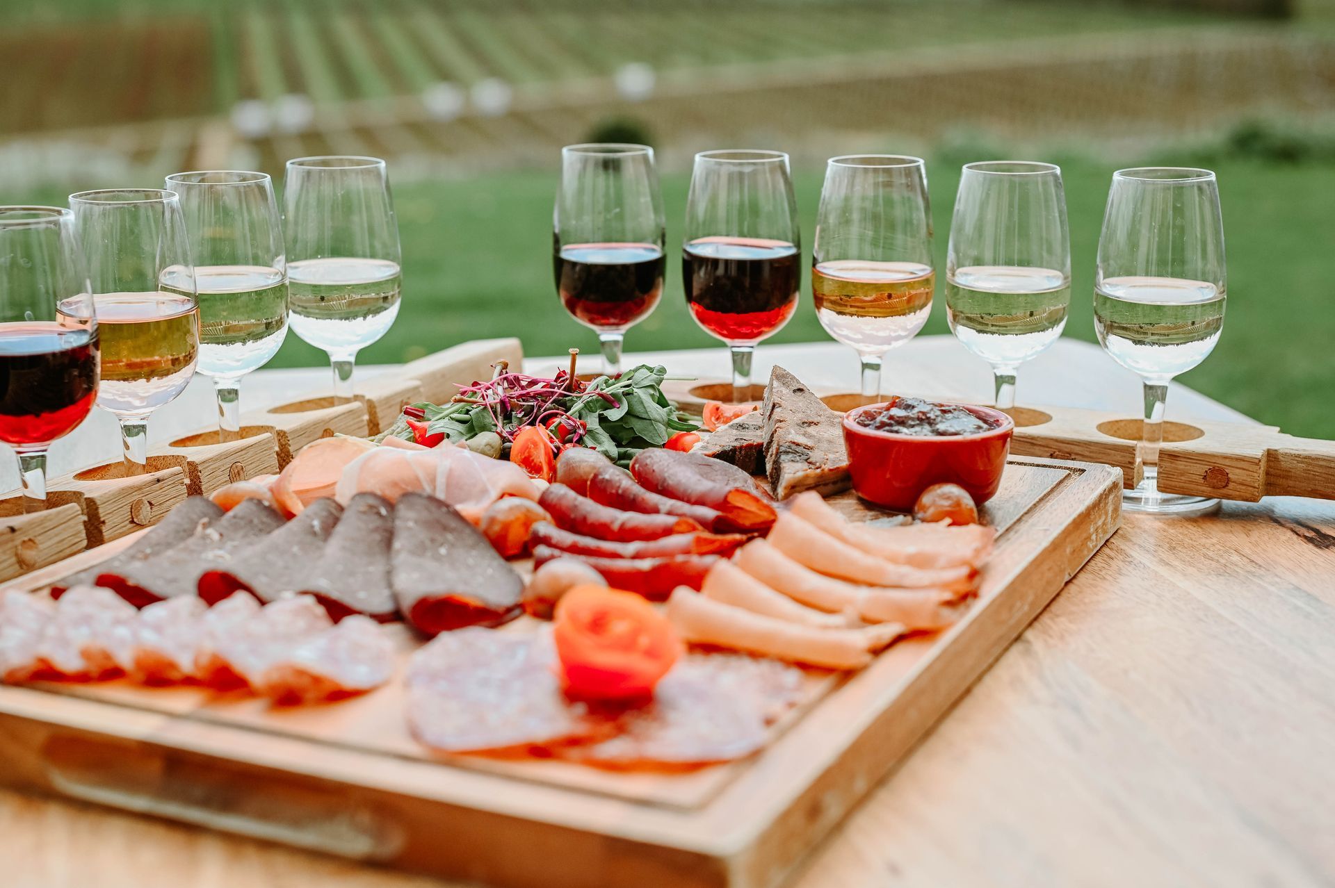 Wine flight ready for tasting, with a charcuterie board for grazing at Three Choirs Vineyards