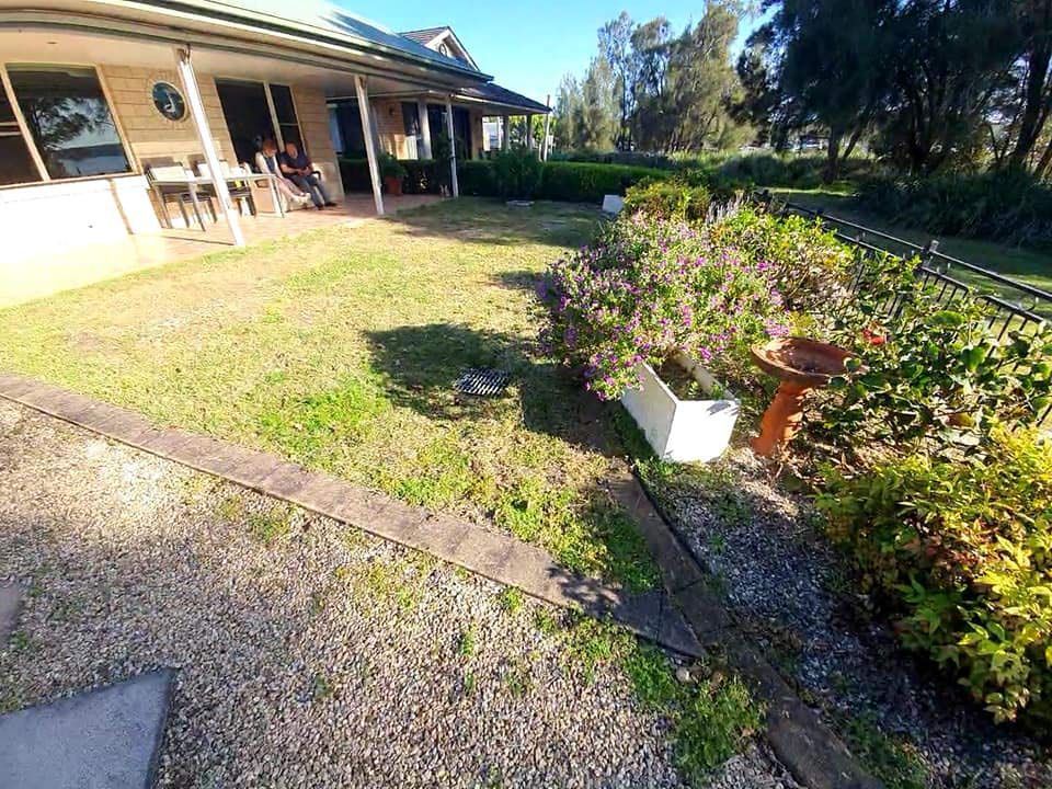 A House With A Large Lawn And A Bird Bath In Front Of It — Green Envy Landscape & Garden Services In Cameron Park NSW