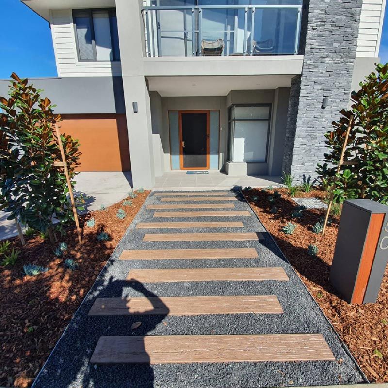 A Walkway Leading To The Front Door Of A House — Green Envy Landscape & Garden Services In Cameron Park NSW