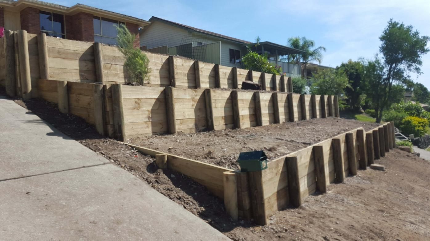 Multi-tiered Wooden Retaining Wall on a Sloped Yard, Ready for Landscaping — Green Envy Landscape & Garden Services In Cameron Park NSW