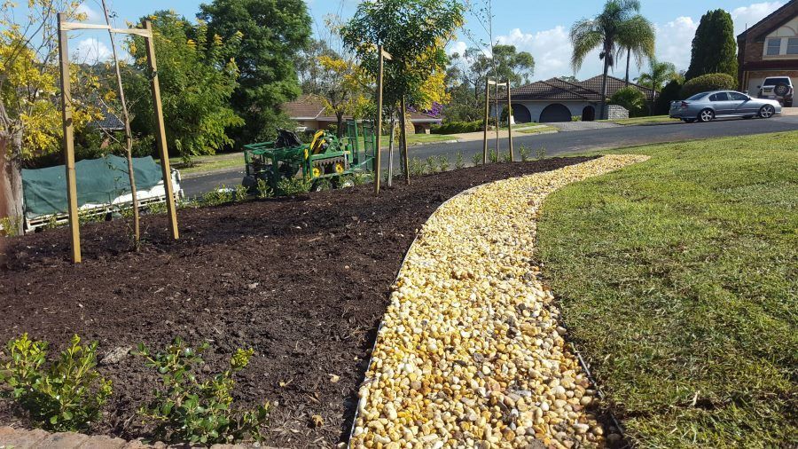 A Lawn And A Car Parked On The Side Of The Road — Green Envy Landscape & Garden Services In Cameron Park NSW