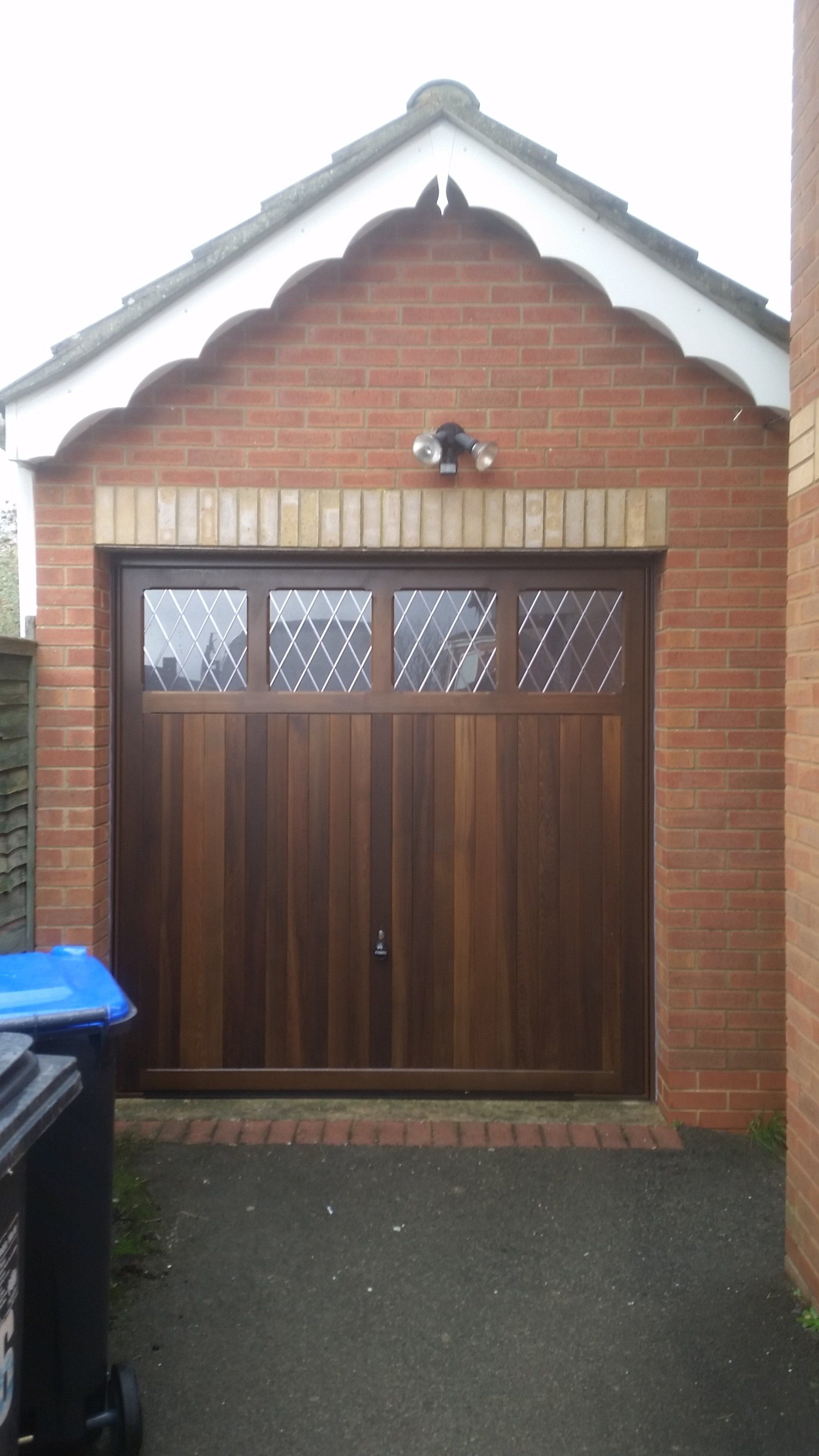 Wooden up and over garage door with windows