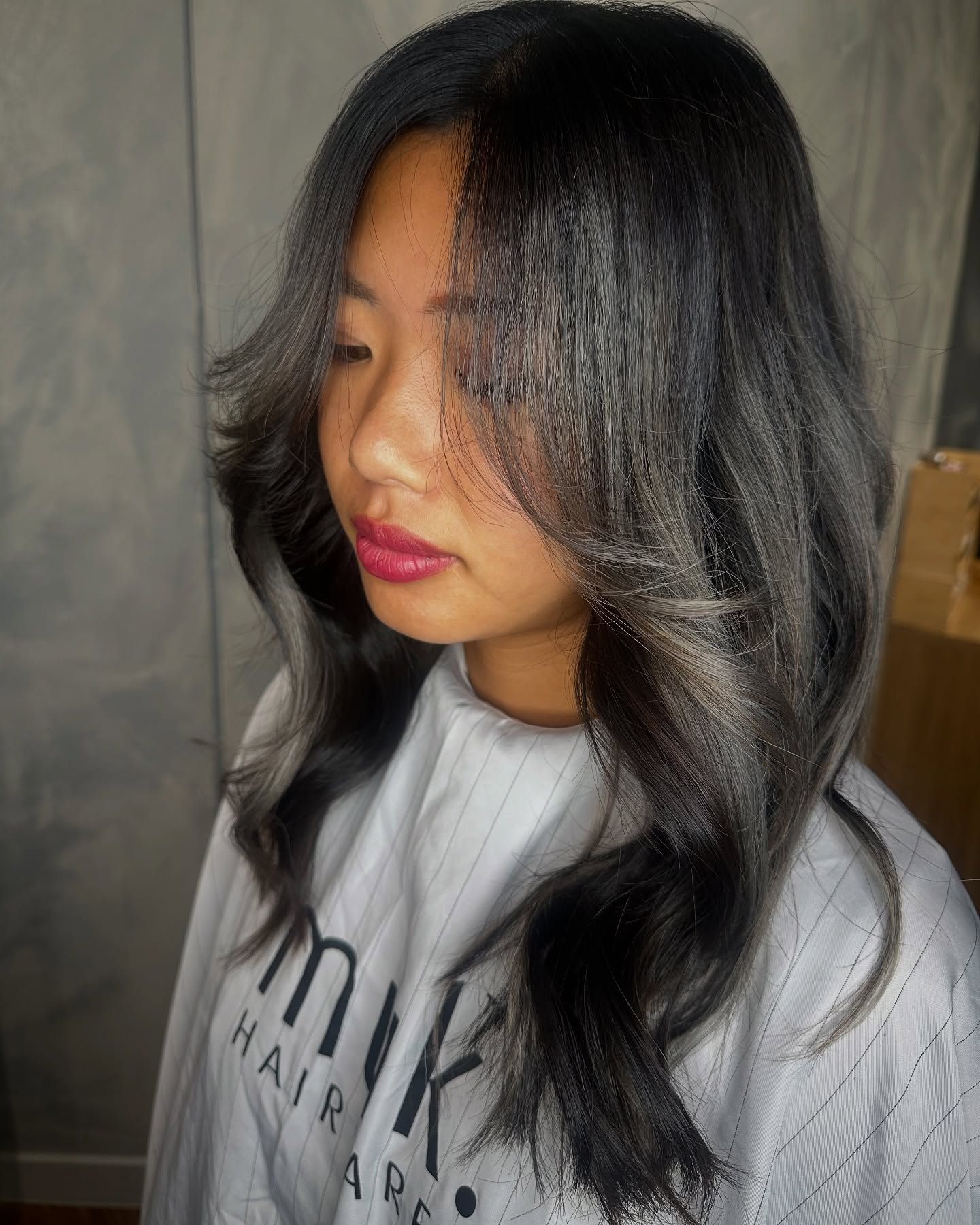 A Woman With Long Blonde Hair is Wearing a White Shirt — AW Hair Studios - Surfers Paradise in Surfers Paradise, QLD