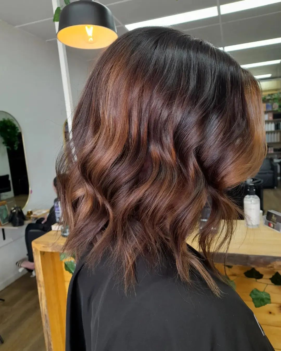 A Woman is Getting Her Hair done by a Hairdresser — AW Hair Studios - Surfers Paradise in Surfers Paradise, QLD