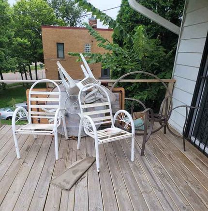 A deck with a bunch of chairs on it