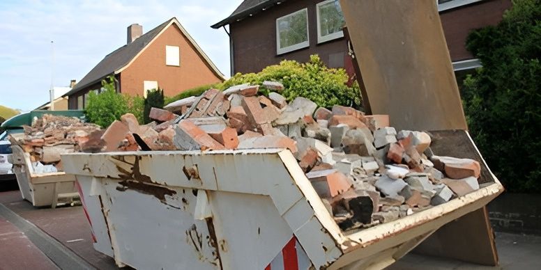 A dumpster filled with bricks is sitting in front of a house.