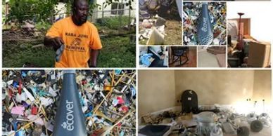 A man in an orange shirt is standing next to a pile of trash.