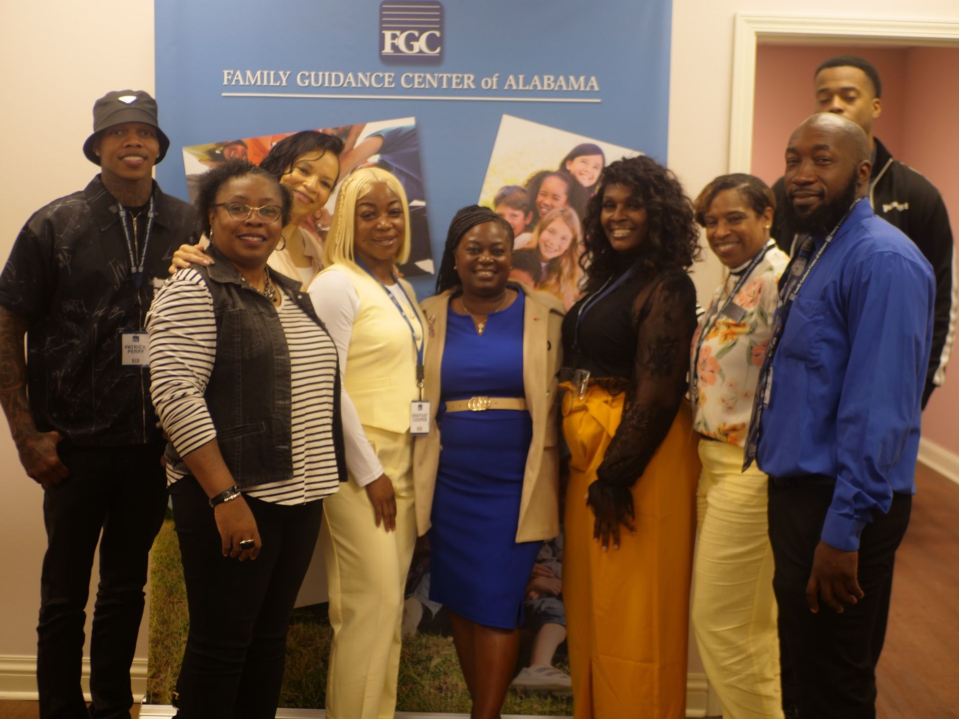 A man in a suit and tie poses for a picture with two women