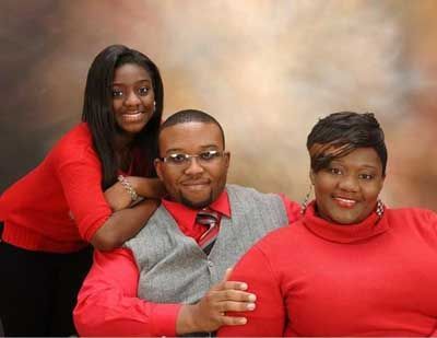 A man and two women are posing for a picture together.