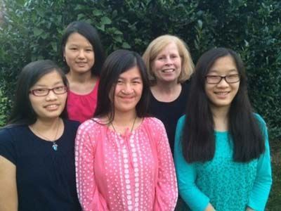A group of young women are posing for a picture together.
