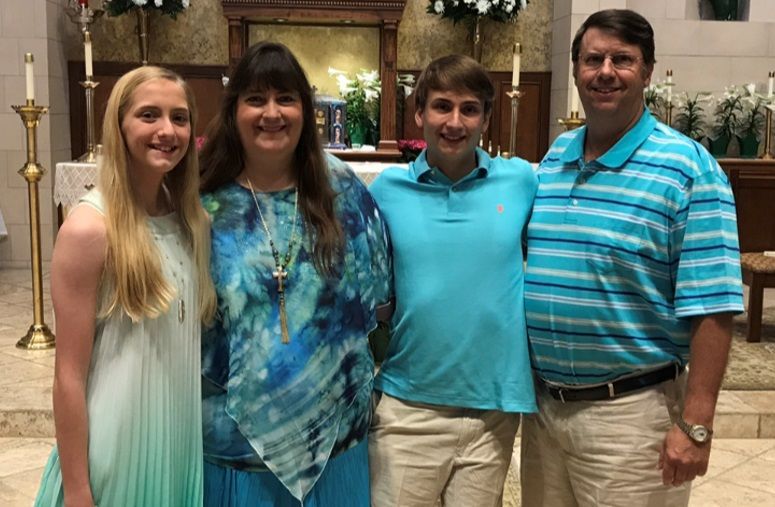 A family is posing for a picture in a church.
