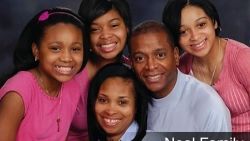 A group of people are posing for a picture together and smiling.