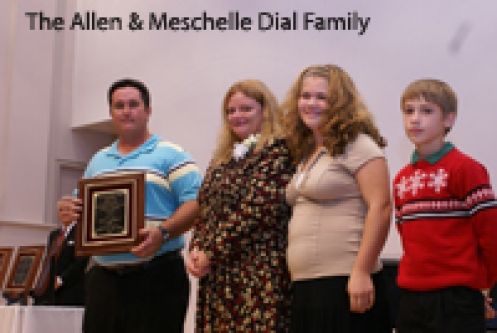 The allen & meschelle dial family is holding a plaque