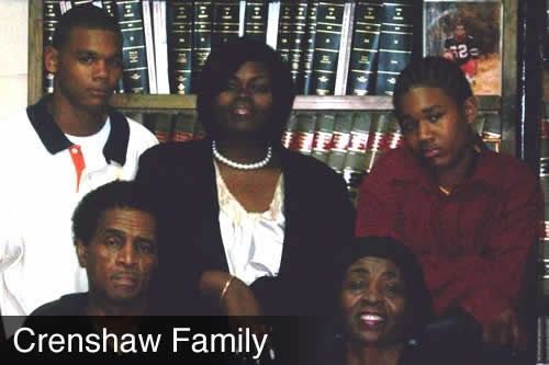 The crenshaw family is posing for a picture in front of a bookshelf