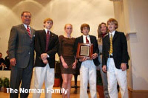 A group of people standing next to each other with the words the norman family on the bottom