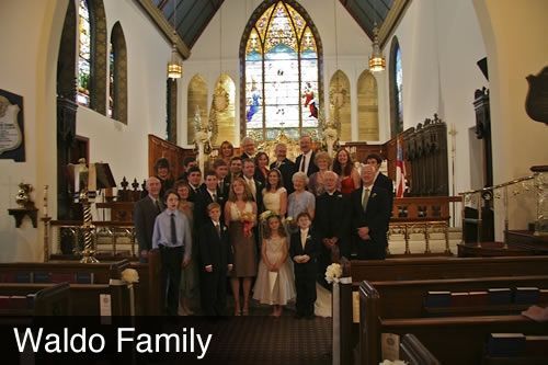 A group of people posing for a picture in a church with the name waldo family on the bottom