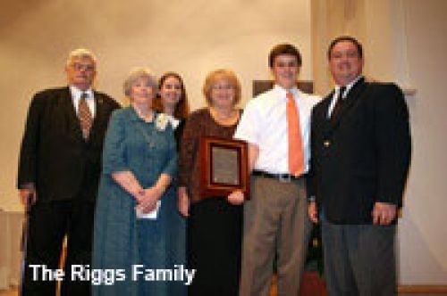 A group of people posing for a picture with the riggs family written on the bottom
