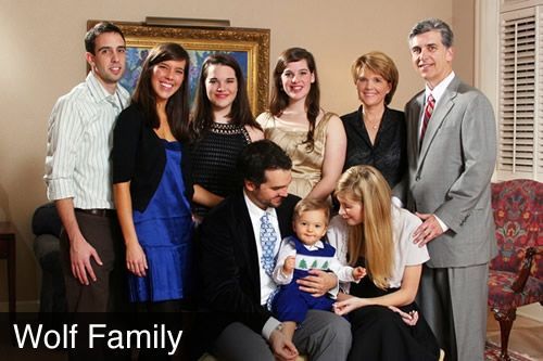 A wolf family posing for a picture in a living room