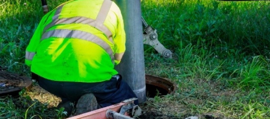 man checking manhole