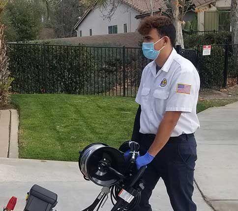 man carrying plumbing machine