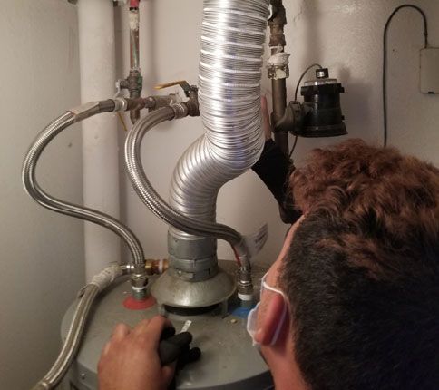 man checking heat tank