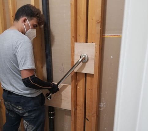man repairing shower