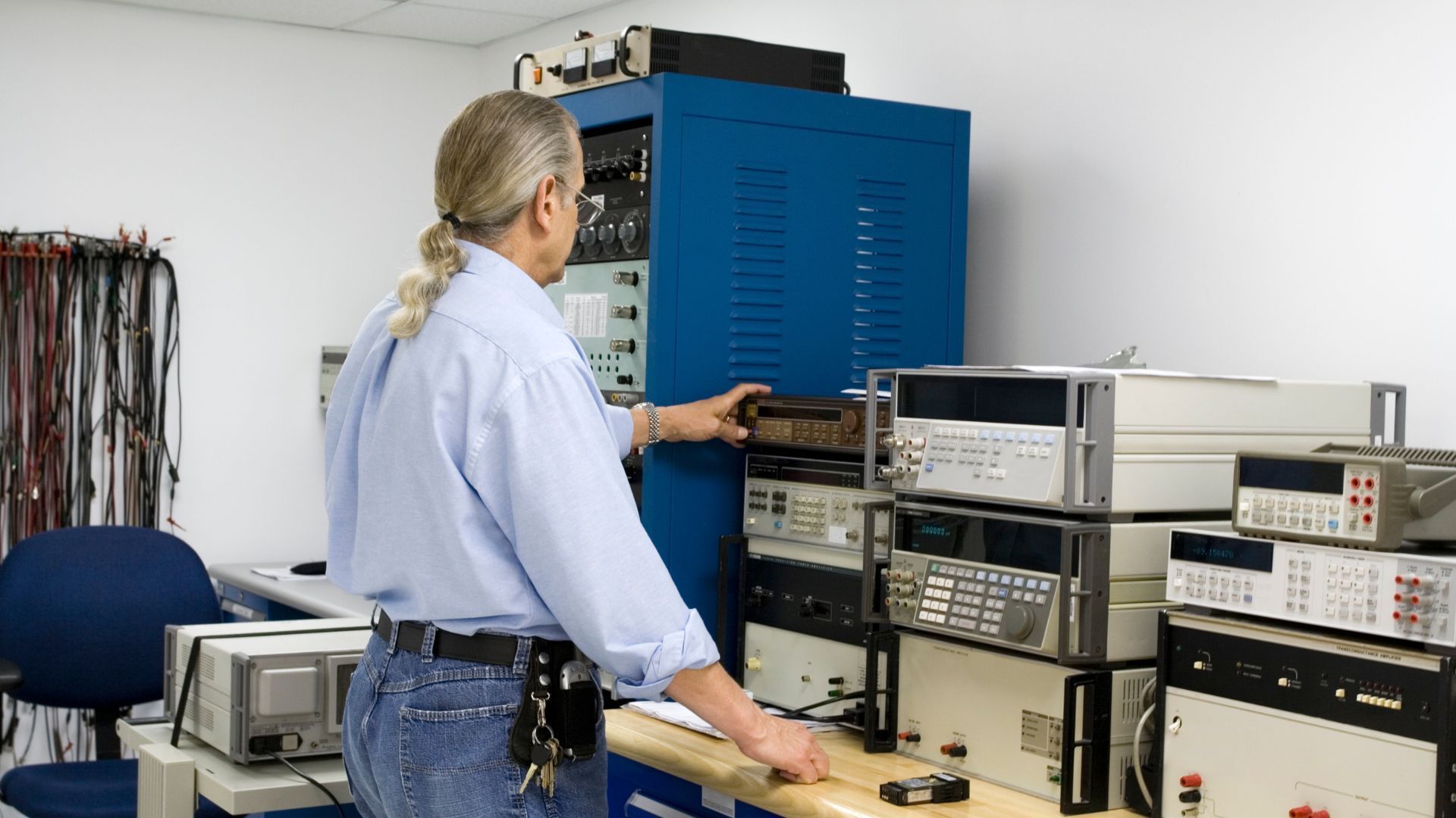 A man in a blue shirt is working in a lab