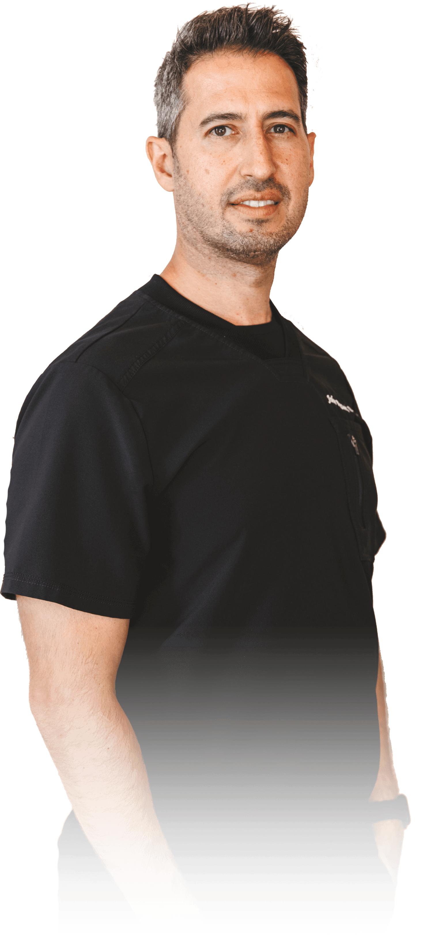 A man in a black shirt is standing in front of a white background.