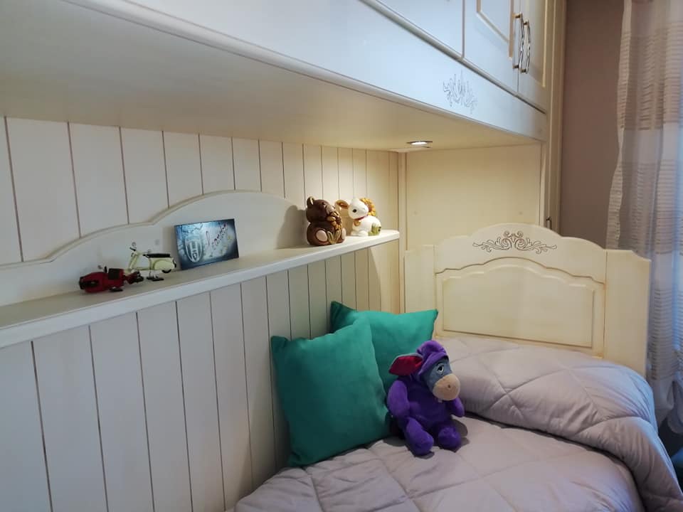 dettaglio letto con mobile a parete in una cameretta