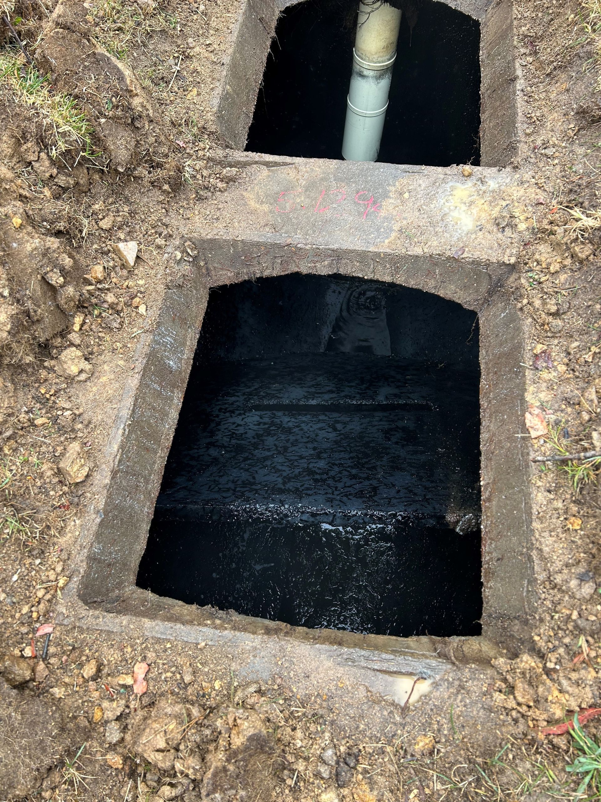 A Man Wearing Red Rubber Gloves Is Opening A Manhole Cover – Bruthen, VIC - Gilmores Septic and Liquid Waste